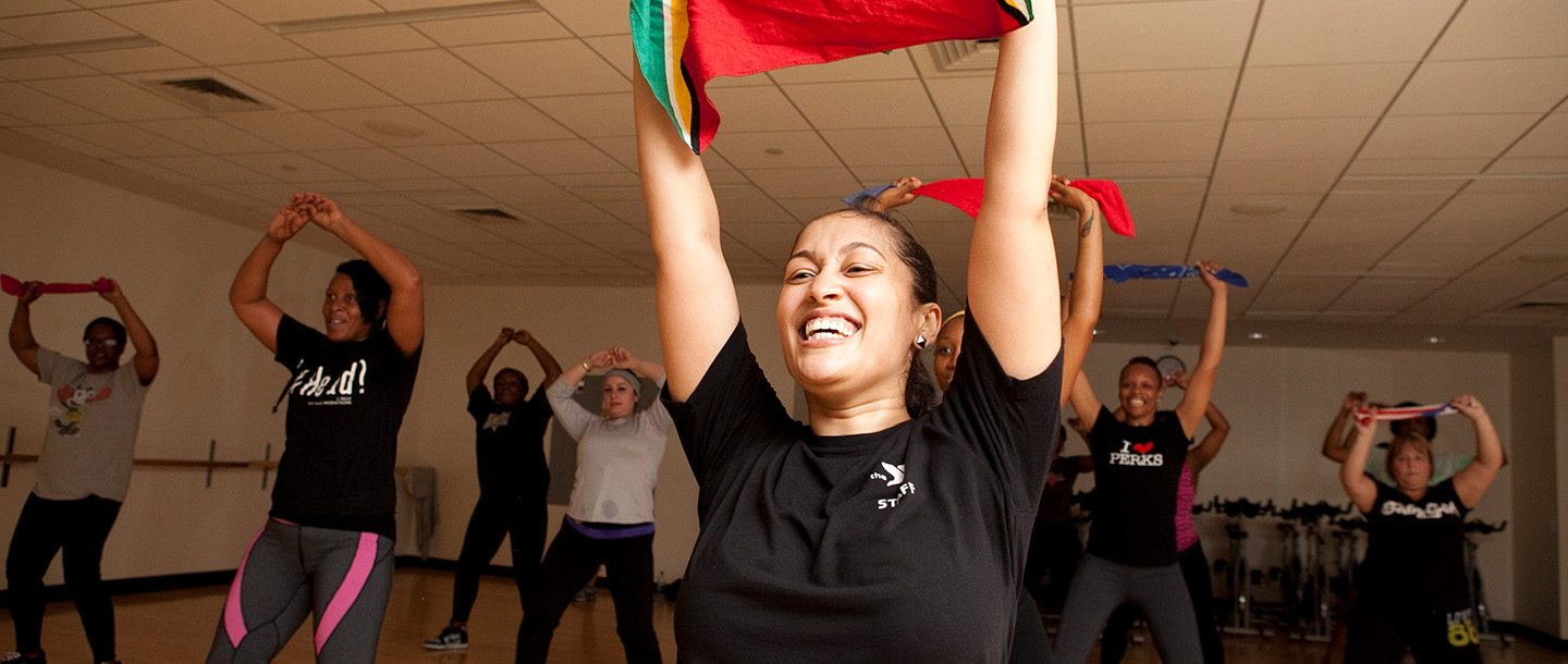 An dance instructor leads a group fitness class at the YMCA.