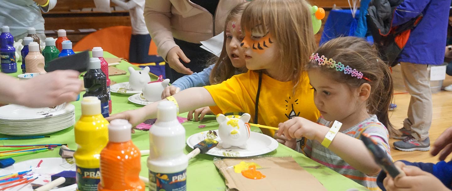 Kids doing arts and crafts at free YMCA event for families