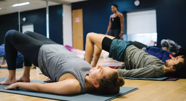 Yoga class doing bridge pose