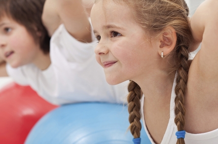 Kids learning yoga skills during youth sports class at the YMCA