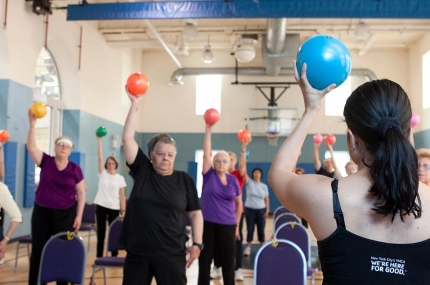 Seniors using equipment in chair yoga class at YMCA