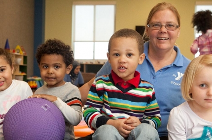 Four children and staff member in child watch room at the YMCA while you work out