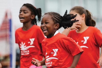 Three girls from summer camp playing outside