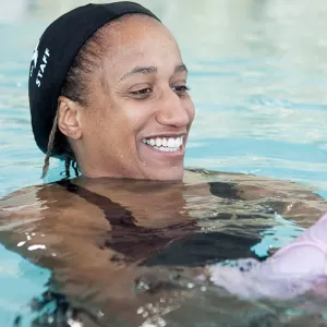 One on one swim lesson instructor teaching young girl in pool at the YMCA in Brooklyn