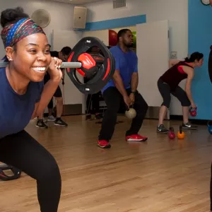 Woman lifting weights in group fitness class