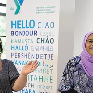 Two women smiling in Flushing YMCA new americans welcome center english classroom