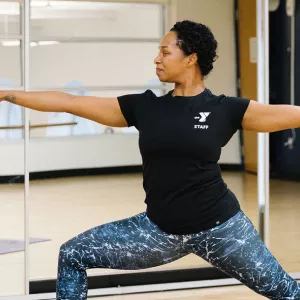 YMCA instructor demonstrating yoga warrior pose