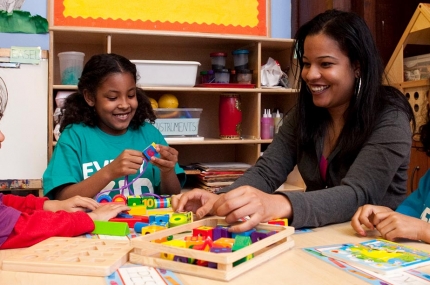 Family playing together on table at YMCA