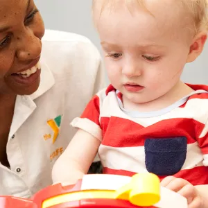 Y staff with toddler in Child Watch at YMCA