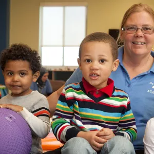 A Y staff member supervises children while their parents work out at the gym.