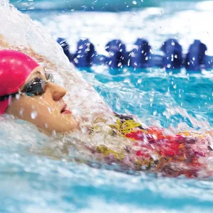 Young swimmer during kid swim team practice