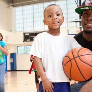 Father and son playing basketball at the YMCA