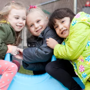 Three girls playing outside of YMCA