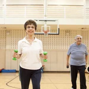 Four women with weights at YMCA fitness class