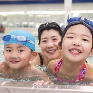 Family swimming at YMCA indoor pool