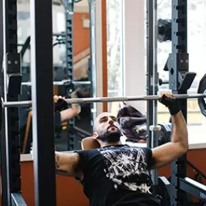 Man bench pressing weights at the Ridgewood YMCA