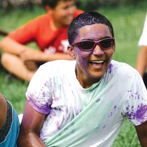 Boy covered in purple paint