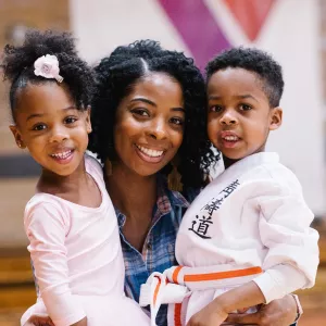 Mom with ballerina and karate kid at West Side YMCA gym