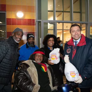 5 people in front of coney island Y holding food